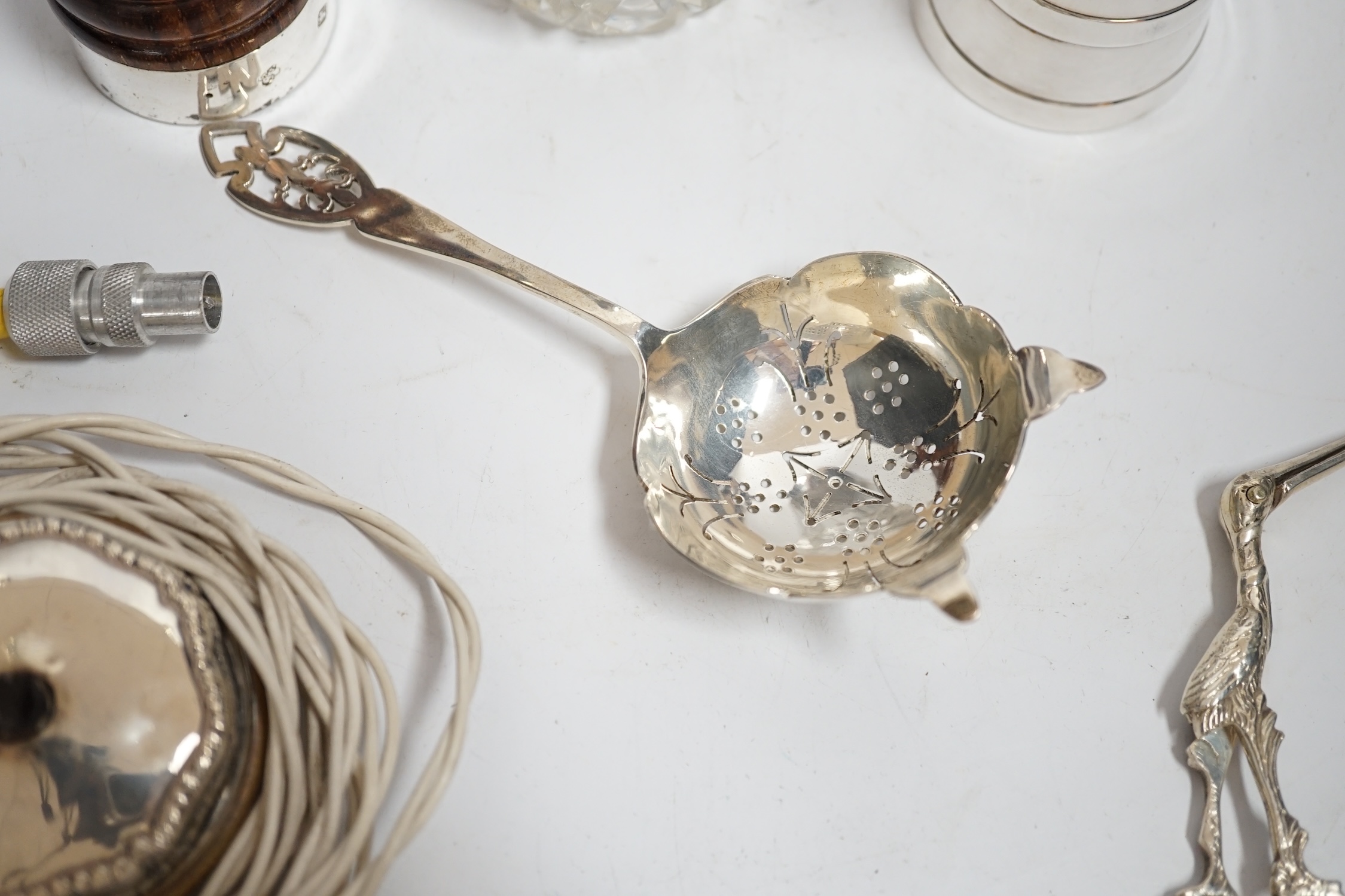 Two modern silver mounted pepper mills, largest 10.2cm, a silver tea strainer, 800 standard white metal mounted glass caster and sundry other items.